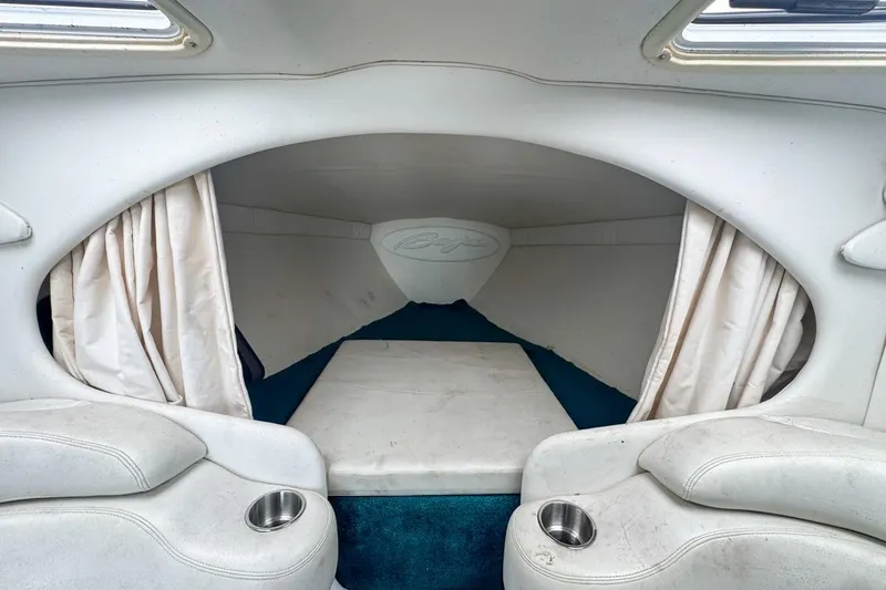 Slide: The Image of 1999 Baja 29 Outlaw boat interior with white seating and blue carpet. - 55