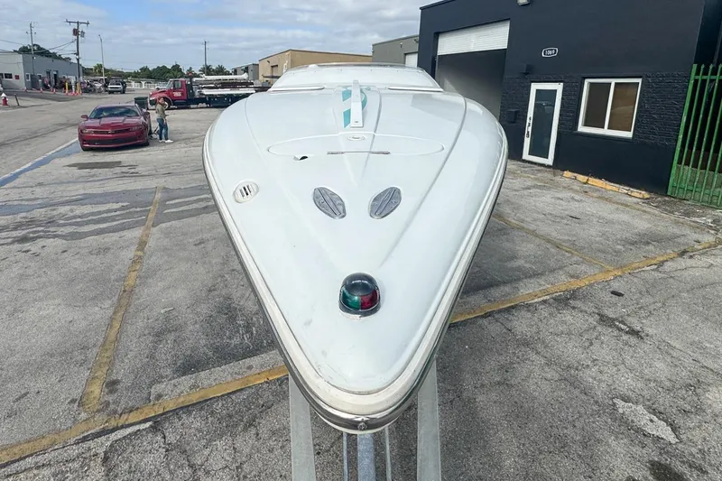 Slide: The Image of 1999 Baja 29 Outlaw boat on trailer in urban setting. - 59