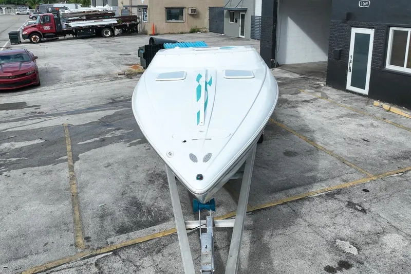 Slide: The Image of 1999 Baja 29 Outlaw boat parked on a trailer. - 61