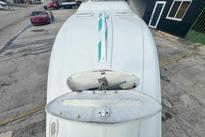 Slide: The Image of 1999 Baja 29 Outlaw boat viewed from above, parked on urban street. - 63