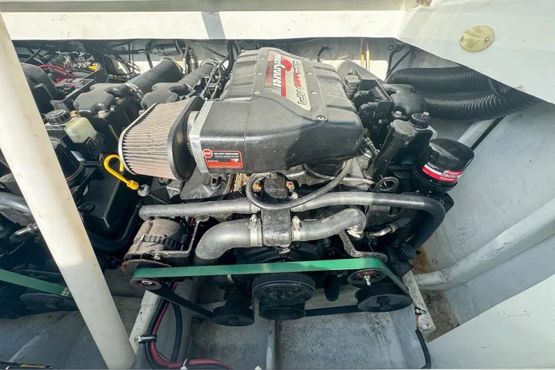 Slide: The Image of 1999 Baja 29 Outlaw engine compartment showcasing powerful marine engine components. - 70