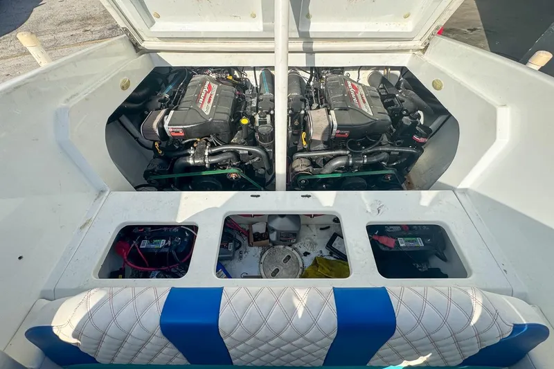 Slide: The Image of 1999 Baja 29 Outlaw boat engine compartment with twin engines and storage area. - 72