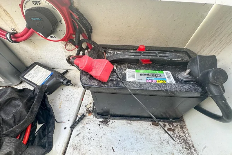 Slide: The Image of Battery setup in a 1999 Baja 29 Outlaw boat with EverStart battery and wiring. - 74