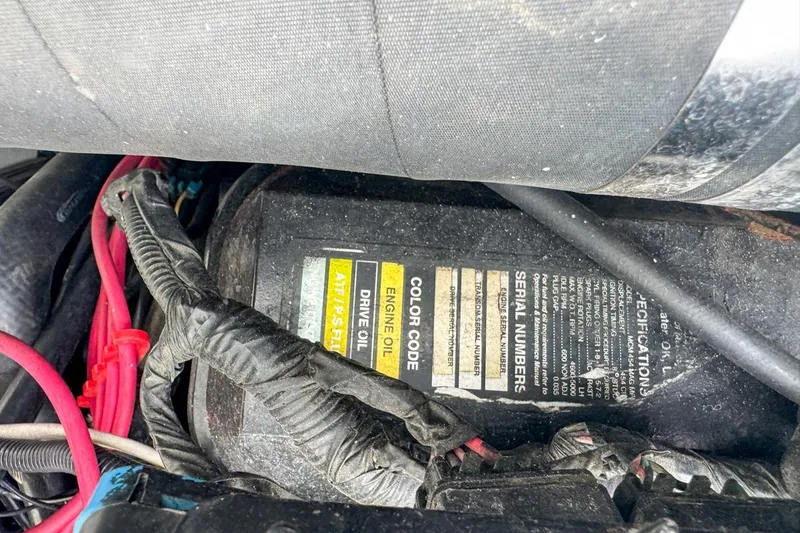 Slide: The Image of 1999 Baja 29 Outlaw engine compartment with visible wiring and specifications label. - 76