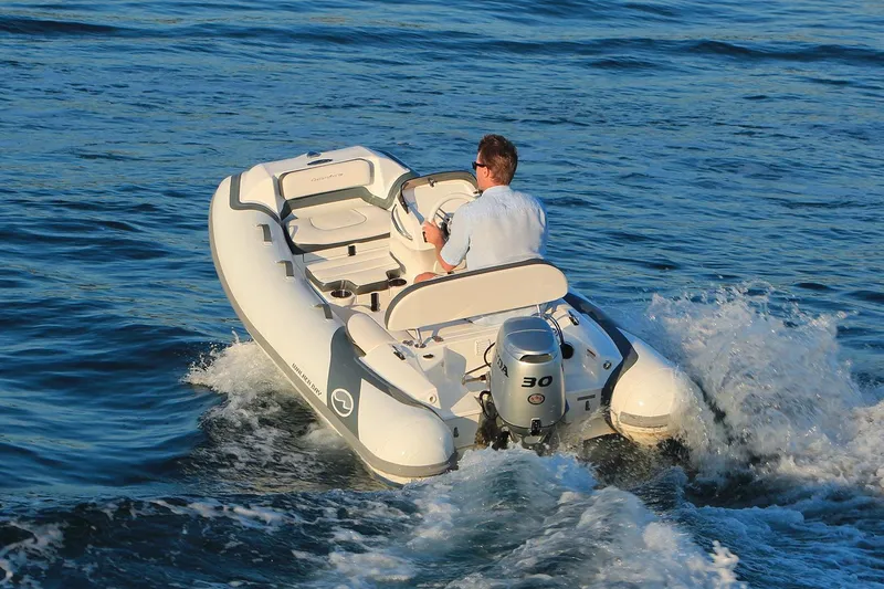Slide: The Image of Manufacturer Provided Image: 2025 Walker Bay Generation 10 LTE boat cruising on open water. - 2