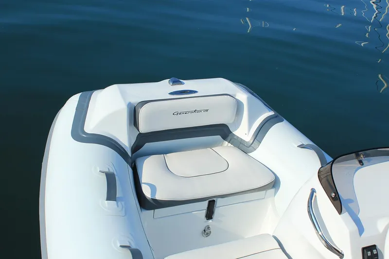 Slide: The Image of Manufacturer Provided Image: 2025 Walker Bay Generation 10 LTE boat interior with cushioned seating on calm water. - 7