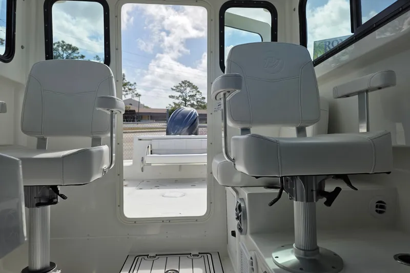 Slide: The Image of Interior of 2026 Parker 227 Explorer boat with two swivel seats and open rear view. - 10