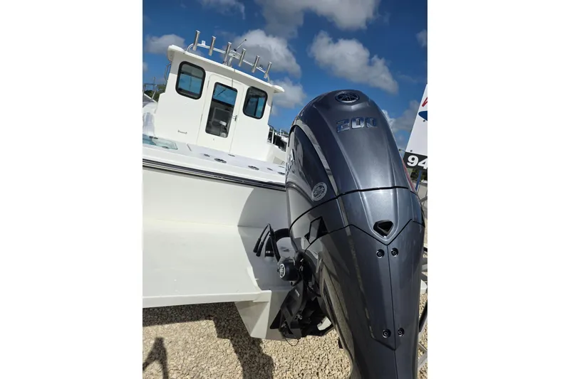 Slide: The Image of 2026 Parker 227 Explorer boat with powerful outboard motor under a clear blue sky. - 14