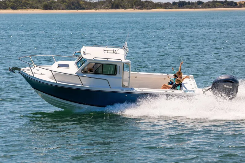 Slide: The Image of Manufacturer Provided Image: 2026 Parker 227 Explorer boat cruising with passengers on a sunny day. - 2