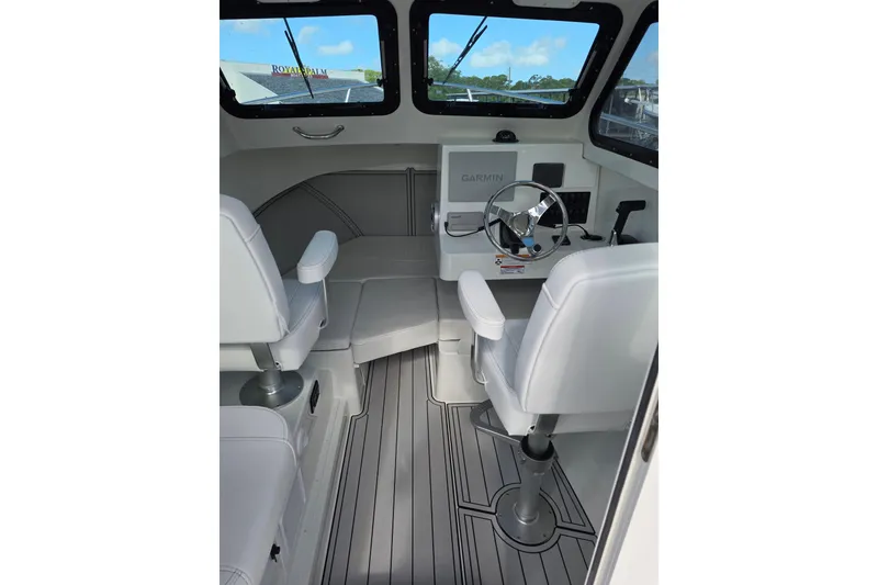 Slide: The Image of Interior of 2026 Parker 227 Explorer boat with modern helm and seating. - 7
