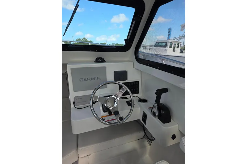 Slide: The Image of Interior helm of 2026 Parker 227 Explorer boat with Garmin navigation system. - 8