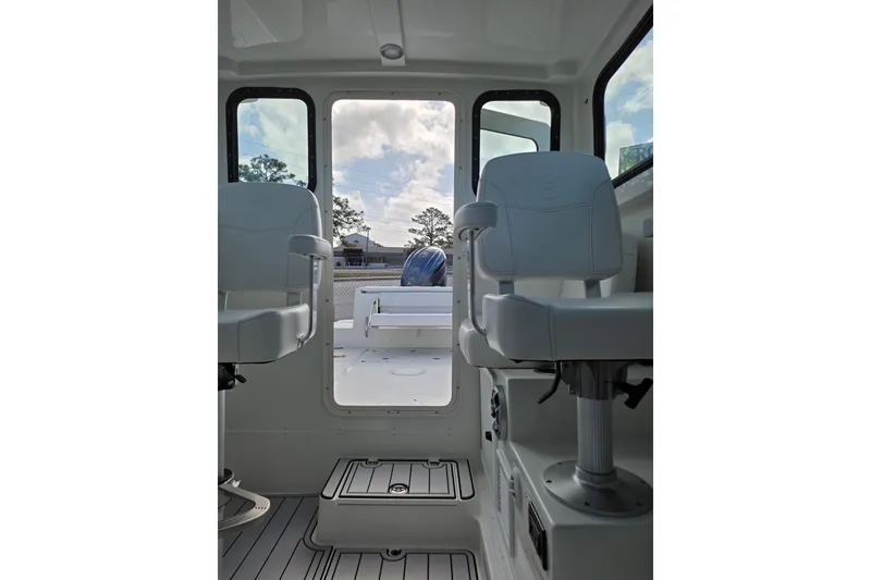 Slide: The Image of Interior view of 2026 Parker 227 Explorer boat, featuring two white seats and a rear door. - 9