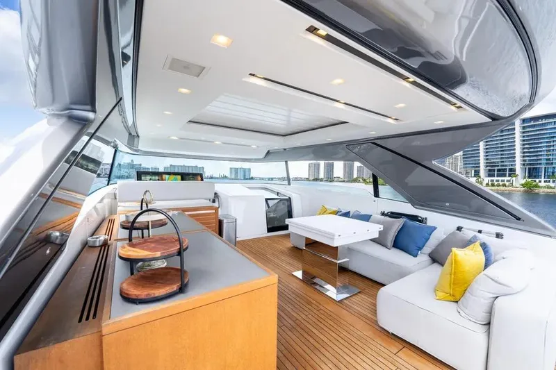 Slide: The Image of Luxurious 2021 Sanlorenzo SX76 yacht interior with modern seating and cityscape view. - 12