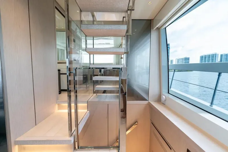 Slide: The Image of Modern interior of 2021 Sanlorenzo SX76 yacht with sleek staircase and large window view. - 23