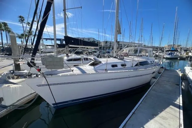 The Image of 2016 Catalina 385 sailboat docked in a marina under a clear blue sky. - 0