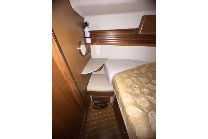 Slide: The Image of Cozy cabin interior of 2016 Catalina 385 sailboat with wooden accents and bedding. - 11