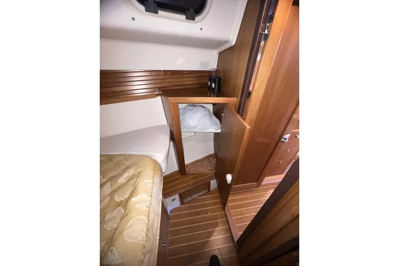Slide: The Image of Interior of 2016 Catalina 385 sailboat with wooden cabinetry and cozy sleeping area. - 12