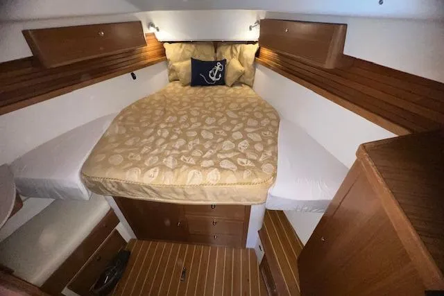 Slide: The Image of Cozy cabin interior of 2016 Catalina 385 sailboat with wood accents and comfortable bedding. - 13