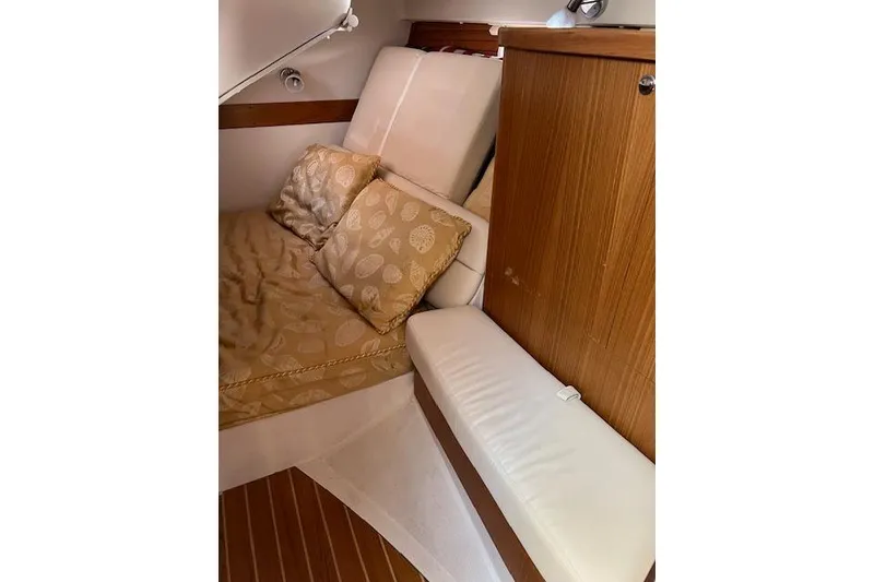 Slide: The Image of Cozy cabin interior of 2016 Catalina 385 sailboat with cushions and wooden cabinetry. - 15