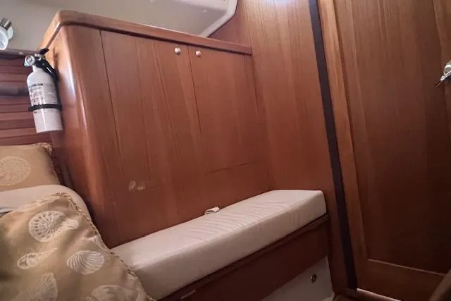Slide: The Image of Interior of 2016 Catalina 385 sailboat with wooden cabinetry and cushioned seating. - 17