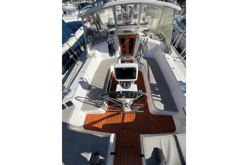 Slide: The Image of Cockpit of 2016 Catalina 385 sailboat with wooden flooring and navigation equipment. - 21