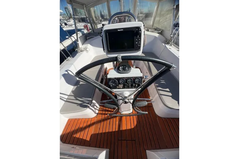 Slide: The Image of Cockpit of 2016 Catalina 385 sailboat with navigation equipment and wooden flooring. - 24