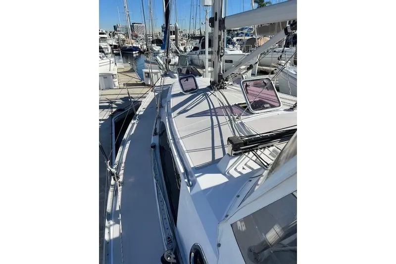 Slide: The Image of 2016 Catalina 385 sailboat docked at marina, showcasing deck and rigging. - 28