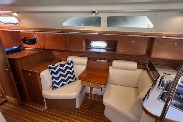 Slide: The Image of Interior of 2016 Catalina 385 sailboat with cozy seating and wooden finishes. - 3