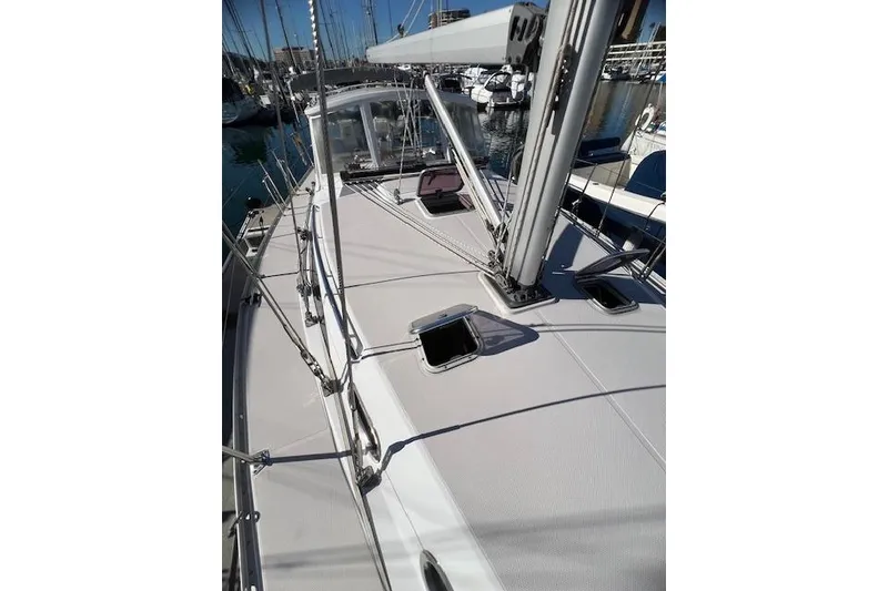 Slide: The Image of Sailboat deck of 2016 Catalina 385, featuring sleek design and marina backdrop. - 33