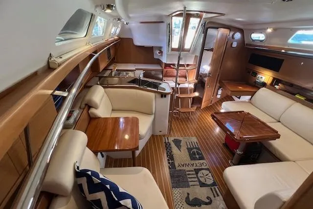 Slide: The Image of Interior of 2016 Catalina 385 sailboat with modern furnishings and wood accents. - 4