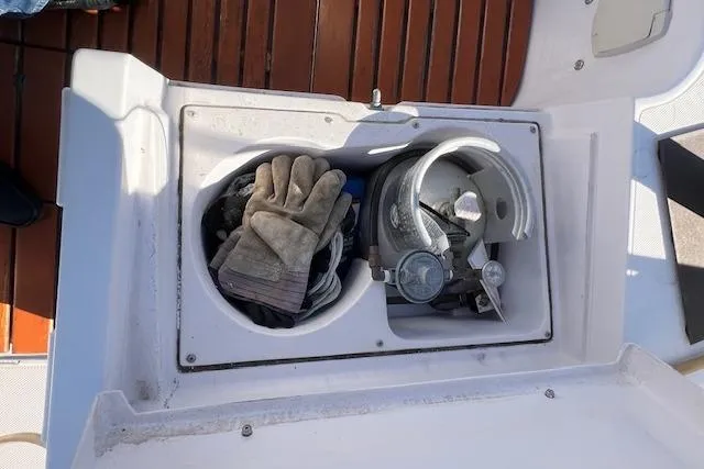 Slide: The Image of Storage compartment on 2016 Catalina 385 sailboat with gloves and equipment. - 43