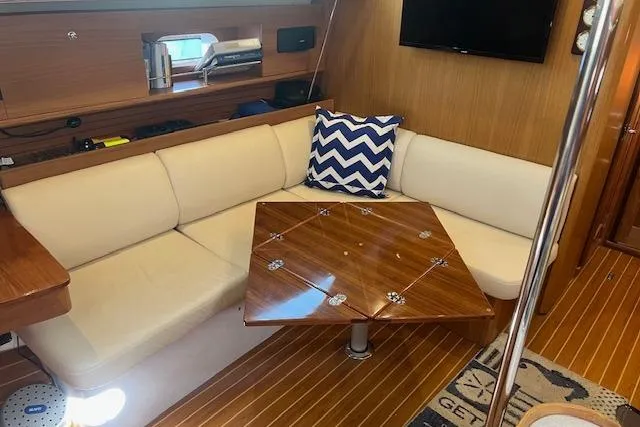 Slide: The Image of 2016 Catalina 385 yacht interior with cozy seating and wooden table. - 5