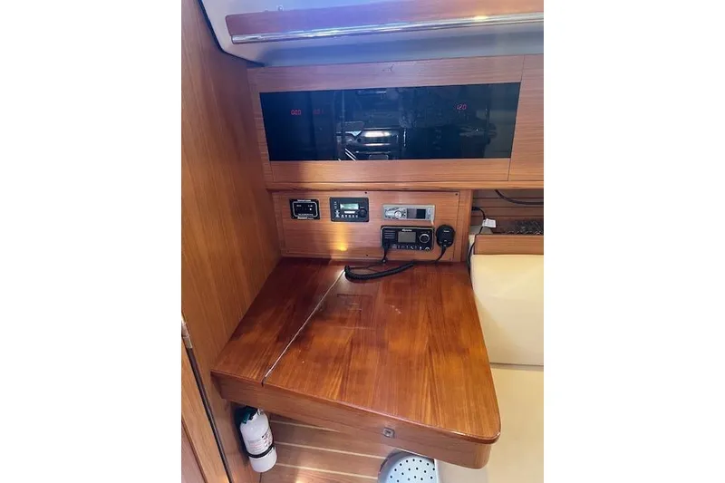 Slide: The Image of Navigation station in 2016 Catalina 385 sailboat with communication equipment and wooden finish. - 6