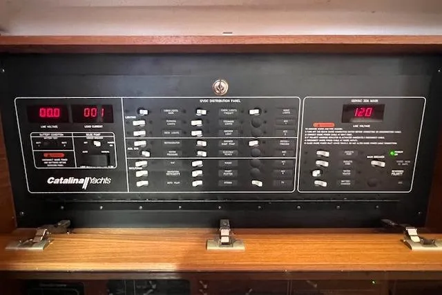 Slide: The Image of Electrical control panel of a 2016 Catalina 385 yacht, featuring various switches and displays. - 7