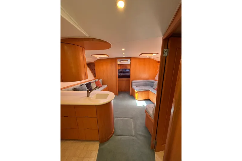 Slide: The Image of Luxurious 2006 Dixon 52 yacht interior with modern wood finish and cozy seating area. - 6