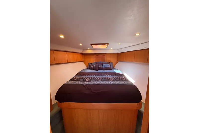 Slide: The Image of Luxurious cabin interior of 2006 Dixon 52 yacht with cozy bedding and wooden accents. - 8