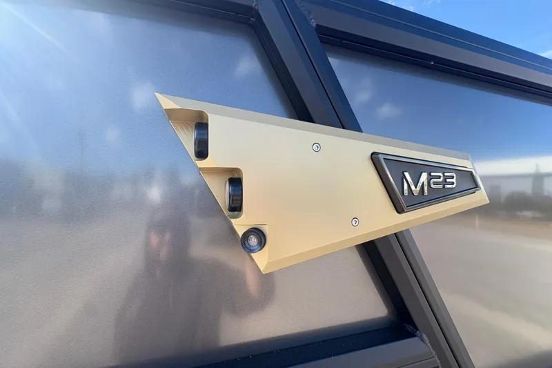 Slide: The Image of Alera M 23L 2026 model badge on sleek metallic surface. - 10
