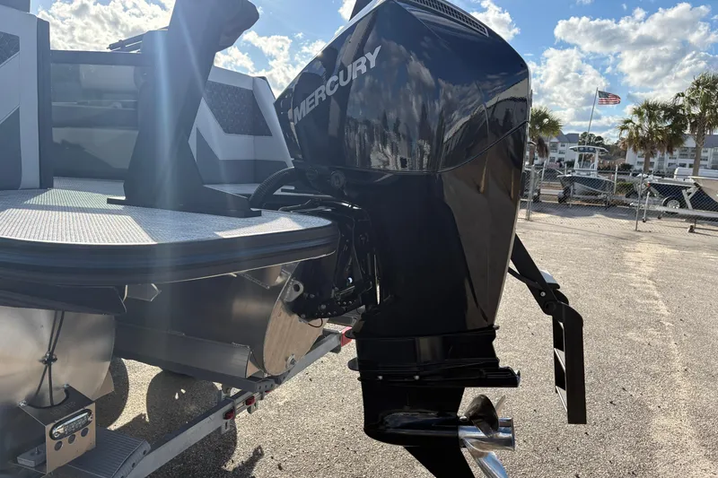 Slide: The Image of 2026 Alera M 23L boat with Mercury outboard motor, parked outdoors under a sunny sky. - 15