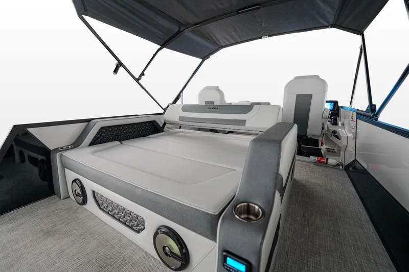 Slide: The Image of 2026 Alera M 23L pontoon boat on trailer, parked outdoors under clear sky. - 2