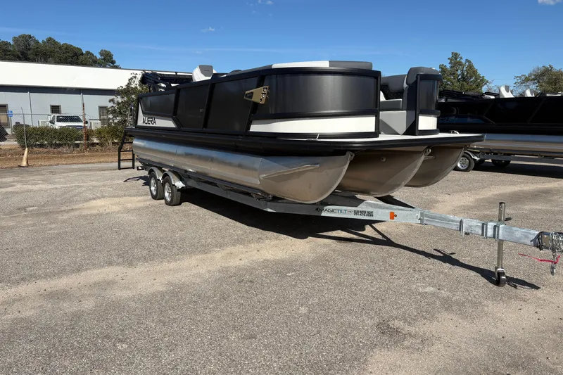 Slide: The Image of Alera M 23L 2026 pontoon boat on trailer in outdoor setting. - 5