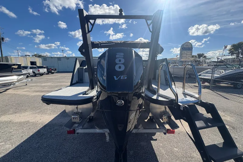 Slide: The Image of Alera M 23L 2026 boat with V6 engine, parked outdoors under a sunny sky. - 6