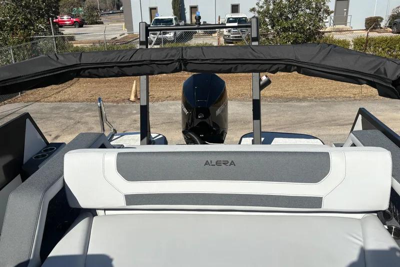 Slide: The Image of 2026 Alera M 23L boat interior with branded seating and outboard motor. - 7