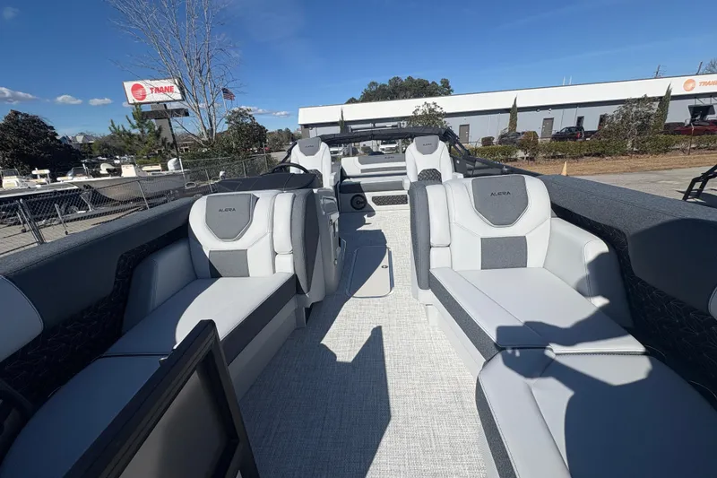 Slide: The Image of 2026 Alera M 23L boat interior with modern seating and steering wheel, outdoor setting. - 9