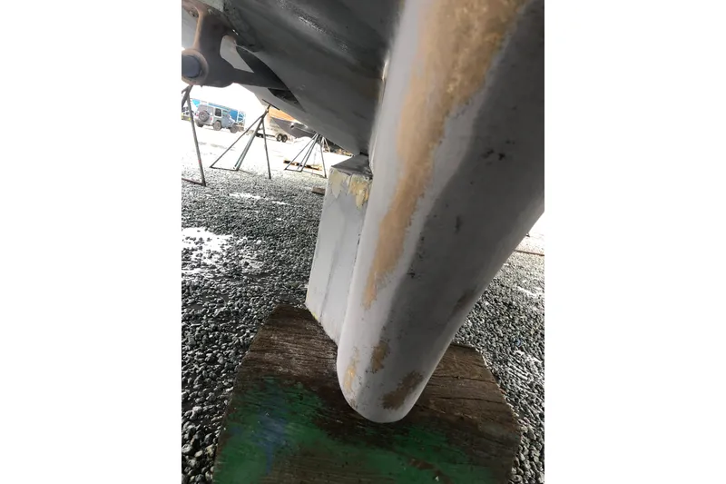 Slide: The Image of 1982 DeFever 52 Offshore Cruiser hull detail on dry dock, showing keel and support. - 12