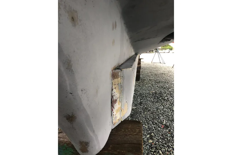 Slide: The Image of 1982 DeFever 52 Offshore Cruiser hull detail, showing wear and surface texture. - 13