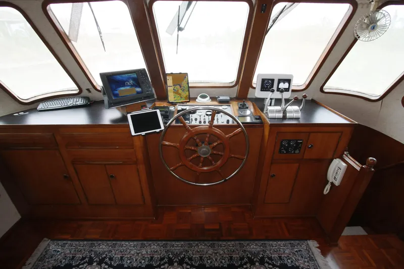 Slide: The Image of Pilothouse of 1982 DeFever 52 Offshore Cruiser with wooden wheel and navigation equipment. - 14