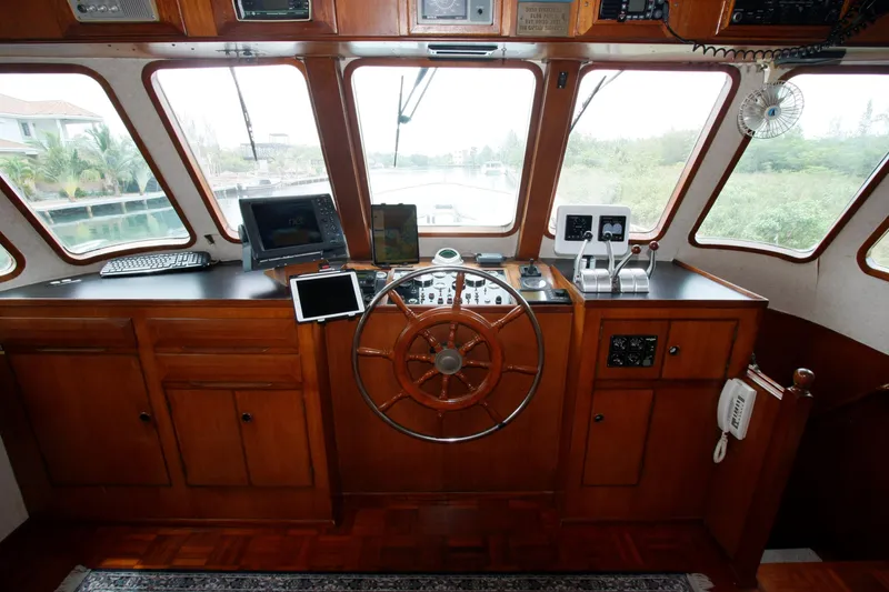 Slide: The Image of 1982 DeFever 52 Offshore Cruiser helm with wooden wheel and navigation equipment. - 15