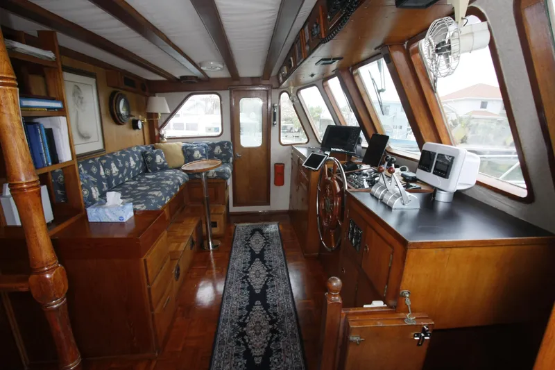 Slide: The Image of Interior of 1982 DeFever 52 Offshore Cruiser with wood paneling and navigation equipment. - 17