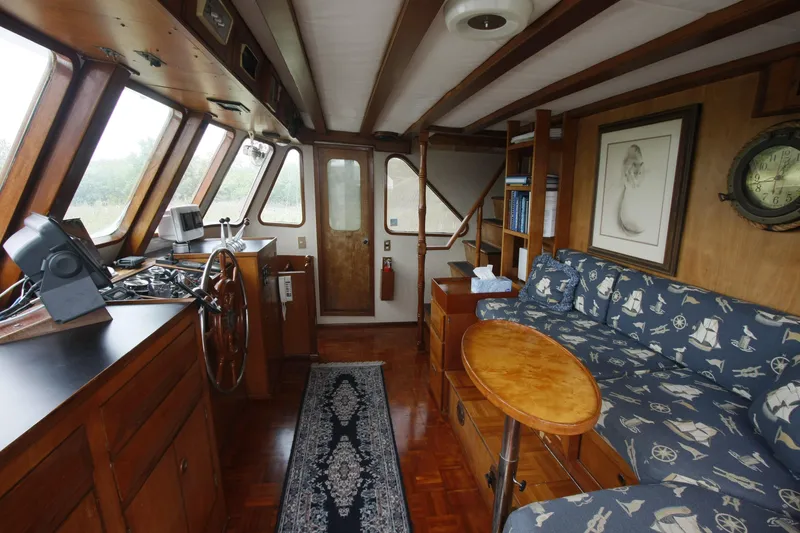Slide: The Image of Interior of 1982 DeFever 52 Offshore Cruiser with nautical-themed decor and wooden furnishings. - 18