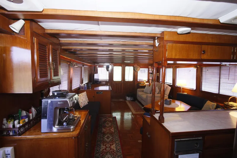 Slide: The Image of Interior of 1982 DeFever 52 Offshore Cruiser with wood paneling and cozy seating area. - 20
